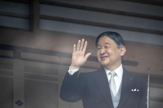 Japan's Emperor Naruhito waves to the public during the traditional New Year's greeting ceremony by Japan's royal family at the Imperial Palace in Tokyo on January 2, 2026. (Photo by Philip FONG / AFP)