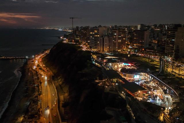 This aerial view shows the shopping center "Larcomar" during the sunset in Miraflores, Lima, on January 1, 2025. (Photo by Connie FRANCE / AFP)