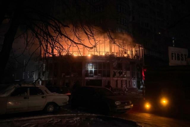 This photograph shows a damaged residential building on fire following a Russian drone strike in Zaporizhzhia on January 2, 2026, amid the Russian invasion of Ukraine. (Photo by Darya NAZAROVA / AFP)