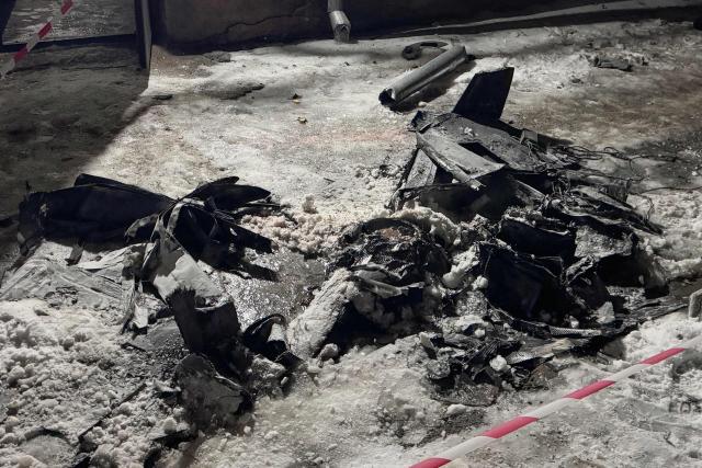 This photograph shows the wreckage of a drone near a damaged residential building following a Russian drone strike in Zaporizhzhia on January 2, 2026, amid the Russian invasion of Ukraine. (Photo by Darya NAZAROVA / AFP)
