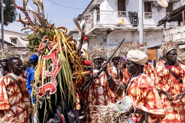 Members of Ebileh hunting society showcase their animal head during the annual New Years Hunting Festival in Banjul on January 1, 2026. Deeply rooted in tradition, the festival has become a cherished New Year celebration in The Gambia, marked by music, dancing, and vibrant masquerades. Held in the capital city, Banjul, the event features a friendly yet fierce competition among hunting societies Ekun Baba, Odilleh, and the recently joined Gun Shot Hunting Society as they showcase striking animal head displays, masks, and elaborate costumes. (Photo by Muhamadou BITTAYE / AFP)