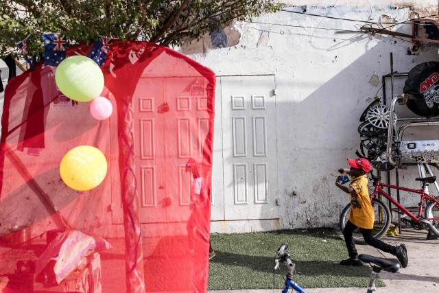 A child plays in the streets ahead of the annual New Years Hunting Festival in Banjul on January 1, 2026. Deeply rooted in tradition, the festival has become a cherished New Year celebration in The Gambia, marked by music, dancing, and vibrant masquerades. Held in the capital city, Banjul, the event features a friendly yet fierce competition among hunting societies Ekun Baba, Odilleh, and the recently joined Gun Shot Hunting Society as they showcase striking animal head displays, masks, and elaborate costumes. (Photo by Muhamadou BITTAYE / AFP)