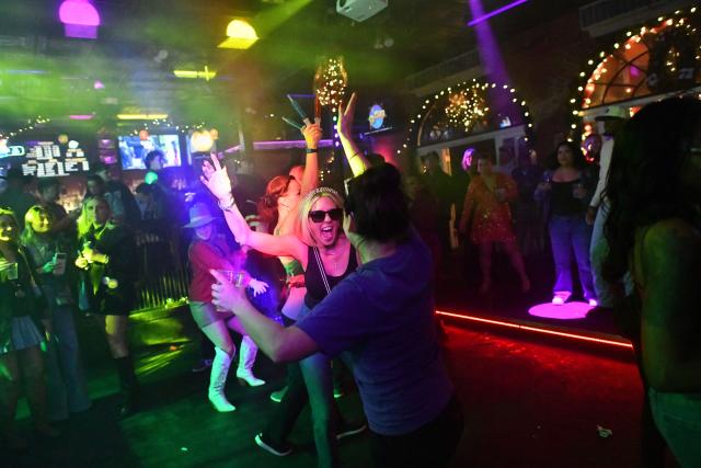 People dance in a nightclub as crowds gather for the College Football Playoffs in New Orleans, Louisiana, on January 1, 2026. (Photo by Octavio JONES / AFP)