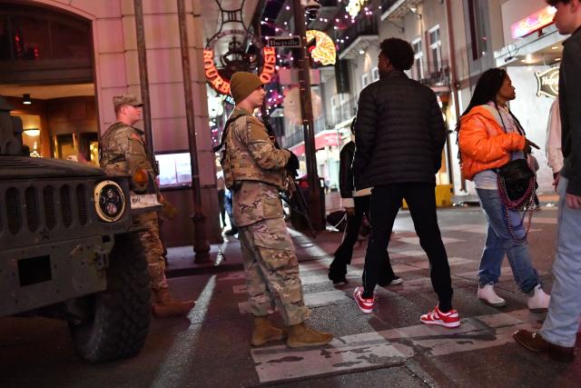 National Guard troops patrol as Ole Miss Rebels fans gather in the French Quarter to celebrate their win over the Georgia Bulldogs in the College Football Playoff in New Orleans, Louisiana, early morning on January 2, 2026. (Photo by Octavio JONES / AFP)