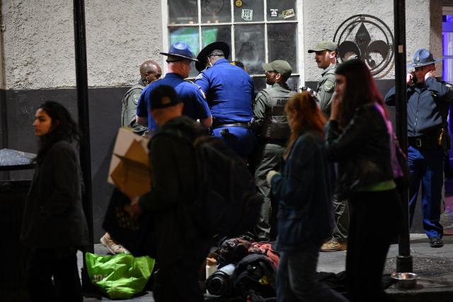 Louisiana local and state law enforcement officers detain a man in the French Quarter as crowds gather for the College Football Playoff game in New Orleans, Louisiana, on January 1, 2026. (Photo by Octavio JONES / AFP)
