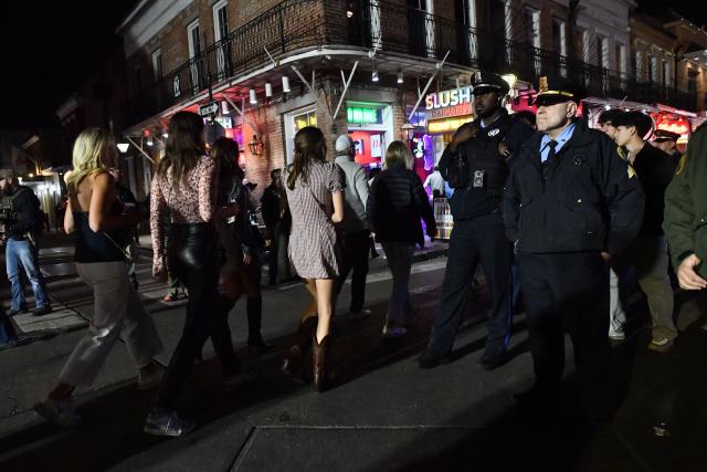 Local and state law enforcement officers stand watch on Bourbon Street in the French Quarter as authorities anticipate large crowds in New Orleans, Louisiana, early morning on January 2, 2026. (Photo by Octavio JONES / AFP)