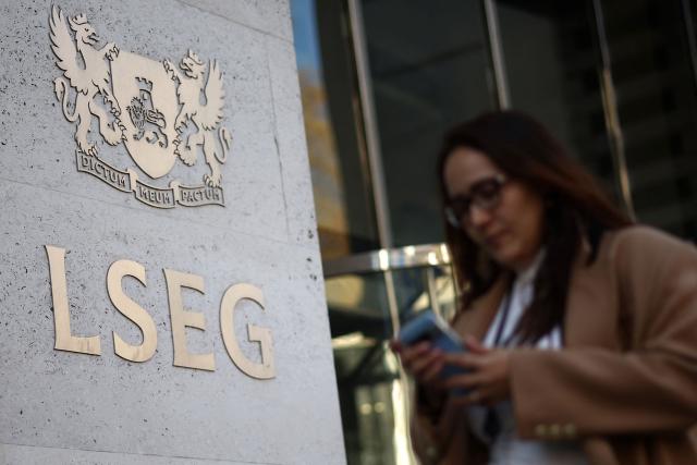 (FILES) A pedestrian walks past the London Stock Exchange Group (LSEG) offices in central London on April 7, 2025. London's benchmark FTSE 100 stocks index topped 10,000 points for the first time on January 2, 2026, extending a record run seen in 2025. (Photo by HENRY NICHOLLS / AFP)