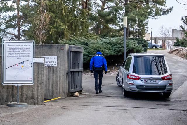A hearse arrives at the funeral home in Sion on January 2, 2026 the day after a fire that ripped through a bar in the Alpine ski resort of Crans-Montana on January 1, 2026, killing several people and injuring others. Investigators raced on January 2, 2026 to identify the victims of a fire that ripped through a bar in the Swiss Alps town of Crans-Montana, turning a New Year's celebration into one of the country's worst tragedies. It is not yet clear what set off the blaze at Le Constellation, killing around 40 people and injuring about 115 others, many seriously. (Photo by MAXIME SCHMID / AFP)