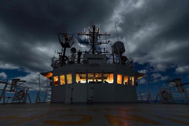 Crew members of the rescue ship "Ocean Viking" operated by the NGO SOS Mediterranee, take part in a night watch as they patrol in the search-and-rescue zone of the international waters of Malta, on January 1, 2026. 33 migrants were rescued by crew members of the migrants rescue ship "Ocean Viking" operated by the NGO SOS Mediterranee. They had been stranded on the oil tanker the 'Maridive 703' since their initial rescue 5 days ago in the joint search zone between Malta and Tunisia in international Mediterranean waters. (Photo by Sameer Al-DOUMY / AFP)