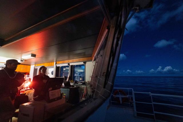 Crew members of the rescue ship "Ocean Viking" operated by the NGO SOS Mediterranee, take part in a night watch as they patrol in the search-and-rescue zone of the international waters of Malta, on January 1, 2026. 33 migrants were rescued by crew members of the migrants rescue ship "Ocean Viking" operated by the NGO SOS Mediterranee. They had been stranded on the oil tanker the 'Maridive 703' since their initial rescue 5 days ago in the joint search zone between Malta and Tunisia in international Mediterranean waters. (Photo by Sameer Al-DOUMY / AFP)