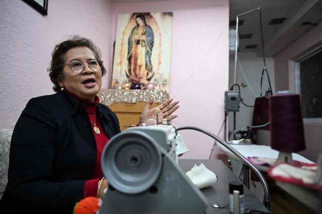 Mexican seamstress and designer Olivia Trujillo Cortes, 63, speaks during an interview in her workshop in San Pedro Martir, on the outskirts of Mexico City, on December 23, 2025. Mexican President Claudia Sheinbaum wore a purple, indigenous-embroidered dress at her first meeting with Donald Trump during the 2026 World Cup draw, a choice seen as symbolizing women's power. That week, The New York Times named her among the world's most stylish figures, highlighting her strategy of blending indigenous craftsmanship with modern elegance to send a political message. (Photo by Yuri CORTEZ / AFP)
