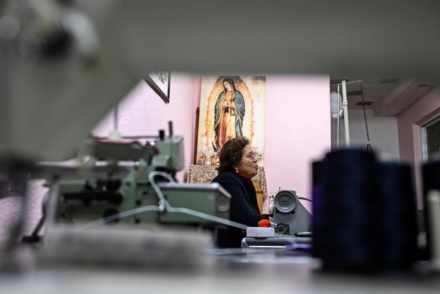 Mexican seamstress and designer Olivia Trujillo Cortes, 63, speaks during an interview in her workshop in San Pedro Martir, on the outskirts of Mexico City, on December 23, 2025. Mexican President Claudia Sheinbaum wore a purple, indigenous-embroidered dress at her first meeting with Donald Trump during the 2026 World Cup draw, a choice seen as symbolizing women's power. That week, The New York Times named her among the world's most stylish figures, highlighting her strategy of blending indigenous craftsmanship with modern elegance to send a political message. (Photo by Yuri CORTEZ / AFP)