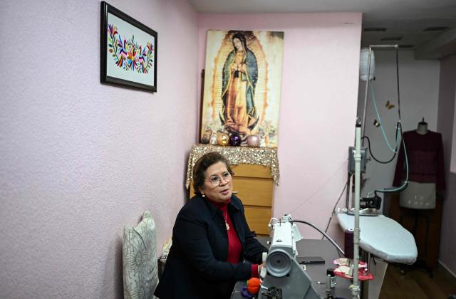 Mexican seamstress and designer Olivia Trujillo Cortes, 63, speaks during an interview in her workshop in San Pedro Martir, on the outskirts of Mexico City, on December 23, 2025. Mexican President Claudia Sheinbaum wore a purple, indigenous-embroidered dress at her first meeting with Donald Trump during the 2026 World Cup draw, a choice seen as symbolizing women's power. That week, The New York Times named her among the world's most stylish figures, highlighting her strategy of blending indigenous craftsmanship with modern elegance to send a political message. (Photo by Yuri CORTEZ / AFP)