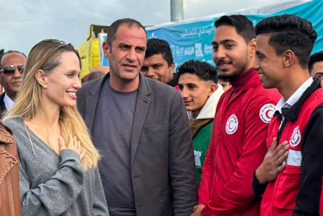 US actress Angelina Jolie greets an employee of the the Egyptian Red Crescent at the Egyptian Rafah border crossing, part of her visit to the North Sinai Governorate to inspect aid entering the Palestinian Gaza Strip, on January 2, 2026, following a two year war that was sparked by Hamas's October 7, 2023 attack on Israel, and which has left the majority of Gaza's 2.4 million people displaced and in need of aid. (Photo by AFP)