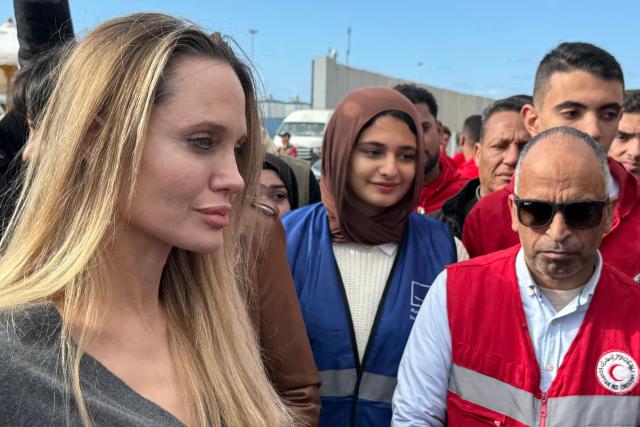 US actress Angelina Jolie meets with employees of the Egyptian Red Crescent at the Egyptian Rafah border crossing, part of her visit to the North Sinai Governorate to inspect aid entering the Palestinian Gaza Strip, on January 2, 2026, following a two year war that was sparked by Hamas's October 7, 2023 attack on Israel, and which has left the majority of Gaza's 2.4 million people displaced and in need of aid. (Photo by AFP)