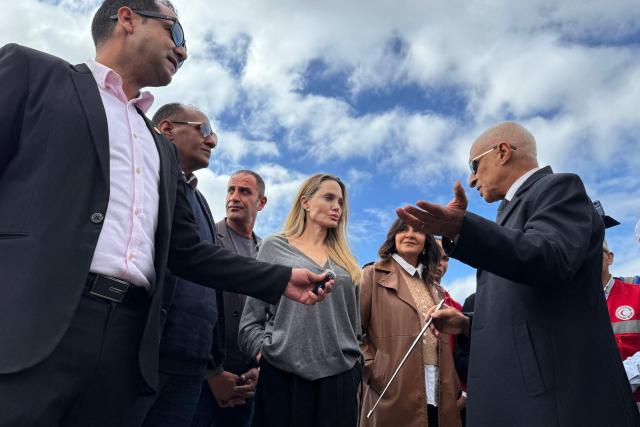 US actress Angelina Jolie (C) speaks with an official at the Egyptian Rafah border crossing, part of her visit to the North Sinai Governorate to inspect aid entering the Palestinian Gaza Strip, on January 2, 2026, following a two year war that was sparked by Hamas's October 7, 2023 attack on Israel, and which has left the majority of Gaza's 2.4 million people displaced and in need of aid. (Photo by AFP)