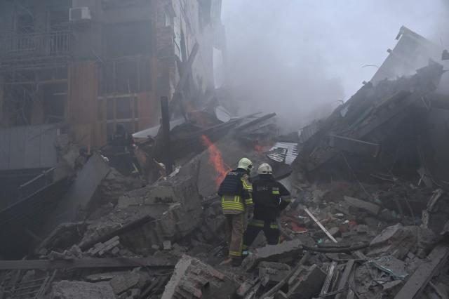 Ukrainian firefighters extinguish a fire in a residential building  following a Russian air strike in Kharkiv on January 2, 2026, amid the Russian invasion of Ukraine. (Photo by SERGEY BOBOK / AFP)