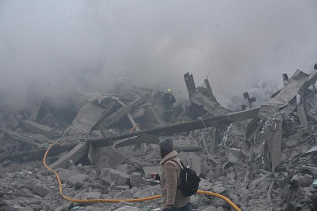 Ukrainian firefighters extinguish a fire in a residential building  following a Russian air strike in Kharkiv on January 2, 2026, amid the Russian invasion of Ukraine. (Photo by SERGEY BOBOK / AFP)