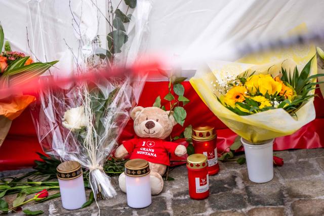 This photograph shows flowers, candles and a teddy bear laid near the site of a fire that ripped through a bar during New Year's Eve celebrations in the Alpine ski resort town of Crans-Montana killing around 40 people and injuring more than 100 others, in Crans-Montana on January 2, 2026. Investigators raced on January 2, 2026 to identify the victims of a fire that ripped through a bar in the Swiss Alps town of Crans-Montana, turning a New Year's celebration into one of the country's worst tragedies. Frederic Gisler, police commander in the Wallis canton in southwestern Switzerland, told reporters that authorities had counted "around 40 people who have died and around 115 injured, most of them seriously". (Photo by MAXIME SCHMID / AFP)