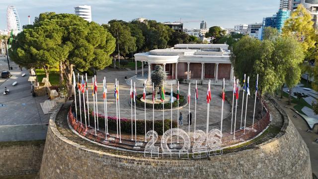 This aerial picture shows flags of EU member states adorning a section of the Venetian Walls of the divided capital Nicosia, on the grounds of the old municipal palace at Eleftheria Square on January 2, 2026. The Republic of Cyprus will hold the Presidency of the Council of the European Union for the first half of 2026. (Photo by Etienne TORBEY / AFP)