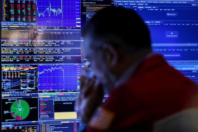 A trader works on the floor of the New York Stock Exchange (NYSE) after the opening bell in New York on January 2, 2026. Wall Street stocks mostly rose to start the new year on Friday, with some advances in tech while home goods stocks picked up too as President Donald Trump postponed planned tariff hikes. (Photo by ANGELA WEISS / AFP)