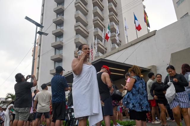 Tourists remain outside after evacuating their hotels during a 6.5 magnitude earthquake in Acapulco, Guerrero state, Mexico on January 2, 2026. A 6.5-magnitude earthquake shook Mexico City and parts of southwestern Guerrero state on Friday, the national seismological service confirmed. (Photo by Francisco ROBLES / AFP)