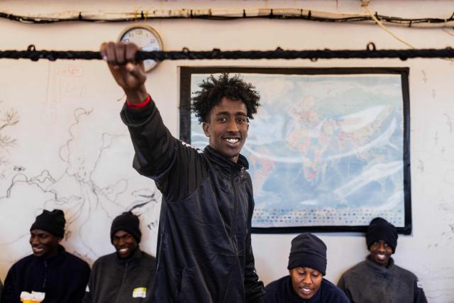 A migrant reacts onboard the rescue ship "Ocean Viking" operated by humanitarian NGO SOS Mediterranee, in the Mediterranean Sea near the Italian coast on January 2, 2026. 33 migrants were rescued by crew members of the migrants rescue ship "Ocean Viking" operated by the NGO SOS Mediterranee. They had been stranded on the oil tanker the 'Maridive 703' since their initial rescue 5 days ago in the joint search zone between Malta and Tunisia in international Mediterranean waters. (Photo by Sameer Al-DOUMY / AFP)
