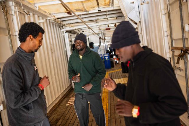 Migrants dance onboard the rescue ship "Ocean Viking" operated by humanitarian NGO SOS Mediterranee, in the Mediterranean Sea near the Italian coast on January 2, 2026. 33 migrants were rescued by crew members of the migrants rescue ship "Ocean Viking" operated by the NGO SOS Mediterranee. They had been stranded on the oil tanker the 'Maridive 703' since their initial rescue 5 days ago in the joint search zone between Malta and Tunisia in international Mediterranean waters. (Photo by Sameer Al-DOUMY / AFP)