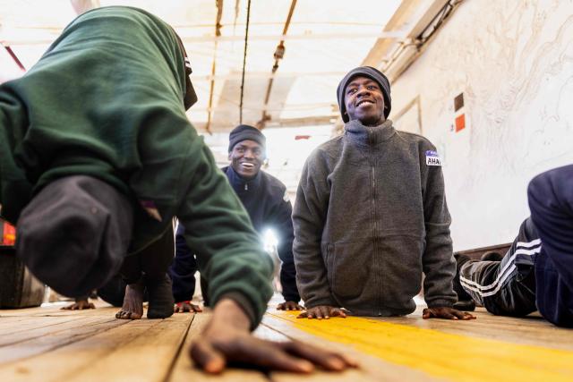 Migrants exercise onboard the rescue ship "Ocean Viking" operated by humanitarian NGO SOS Mediterranee, in the Mediterranean Sea near the Italian coast on January 2, 2026. 33 migrants were rescued by crew members of the migrants rescue ship "Ocean Viking" operated by the NGO SOS Mediterranee. They had been stranded on the oil tanker the 'Maridive 703' since their initial rescue 5 days ago in the joint search zone between Malta and Tunisia in international Mediterranean waters. (Photo by Sameer Al-DOUMY / AFP)