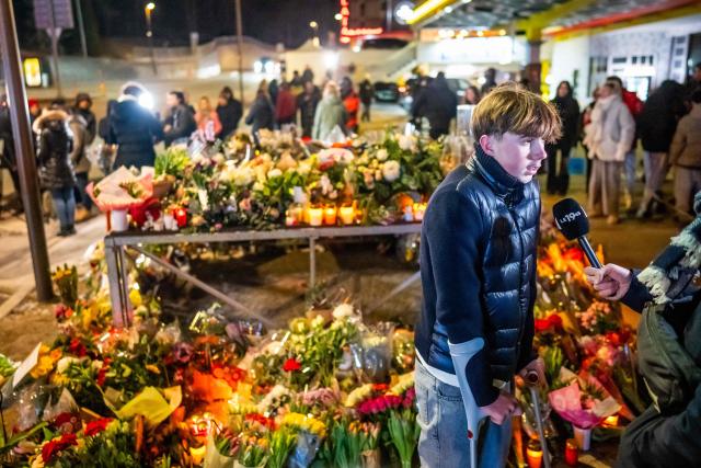An injured survivor speaks to the press next to a makeshift memorial near the site of a fire that ripped through a bar during New Year's Eve celebrations in the Alpine ski resort town of Crans-Montana killing around 40 people and injuring more than 100 others, in Crans-Montana on January 2, 2026. Investigators raced on January 2, 2026 to identify the victims of a fire that ripped through a bar in the Swiss Alps town of Crans-Montana, turning a New Year's celebration into one of the country's worst tragedies. Frederic Gisler, police commander in the Wallis canton in southwestern Switzerland, told reporters that authorities had counted "around 40 people who have died and around 115 injured, most of them seriously". (Photo by MAXIME SCHMID / AFP)