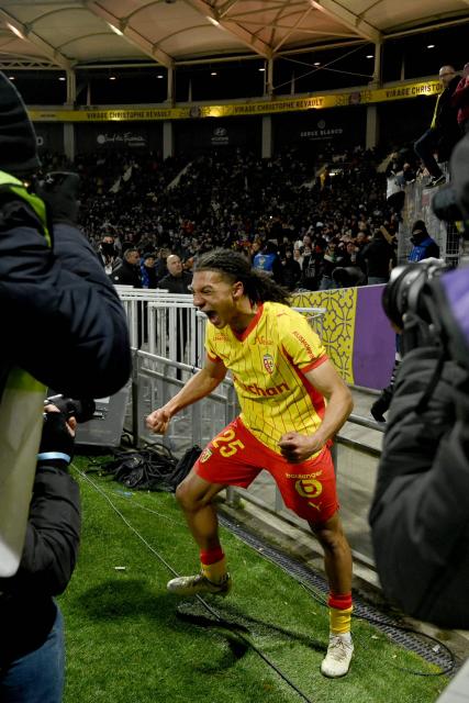 Lens' French defender #25 Ismaelo Ganiou (C) celebrates in front of photographers after scoring Lens' third goal during the French L1 football match between Toulouse FC and RC Lens at the TFC Stadium in Toulouse, southwestern France, on January 2, 2026. (Photo by Matthieu RONDEL / AFP)