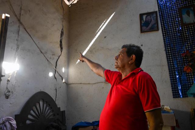 Rogelio Moreno shows his damaged house after a 6.5 magnitude earthquake in the community of San Marcos, Guerrero state, Mexico on January 2, 2026. A 6.5-magnitude earthquake rattled Mexico's capital and a tourist hotspot on  the Pacific coast on Friday, killing at least one person but causing no serious damage. (Photo by Francisco ROBLES / AFP)