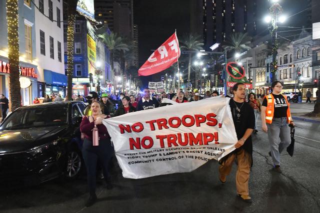 Protesters march through the French Quarter during a "No Trump, No Troops" rally against President Trump's immigration policies and Louisiana Governor Jeff Landry's National Guard deployment, in New Orleans, Louisiana on January 2, 2026. (Photo by Octavio JONES / AFP)