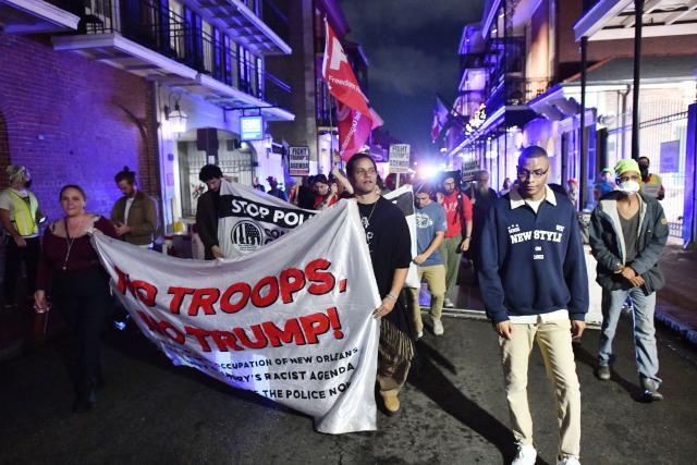 Protesters march through the French Quarter during a "No Trump, No Troops" rally against President Trump's immigration policies and Louisiana Governor Jeff Landry's National Guard deployment, in New Orleans, Louisiana on January 2, 2026. (Photo by Octavio JONES / AFP)