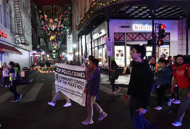 Protesters march through the French Quarter during a "No Trump, No Troops" rally against President Trump's immigration policies and Louisiana Governor Jeff Landry's National Guard deployment, in New Orleans, Louisiana on January 2, 2026. (Photo by Octavio JONES / AFP)