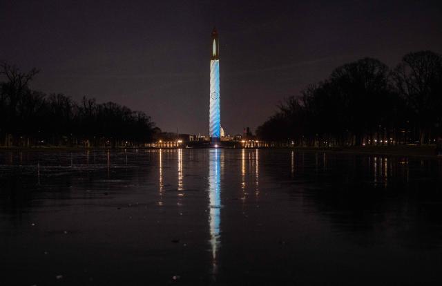 A candle is projected onto the Washington Monument during the "Illumination of America" event marking America’s 250th anniversary at the National Mall in Washington, DC, on January 2, 2026. (Photo by ANDREW CABALLERO-REYNOLDS / AFP)