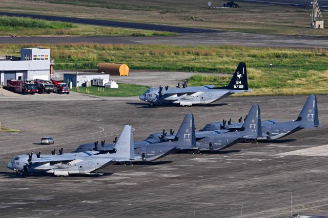 A US Marine Corps KC-130J Hercules and a US Air Force C-130 Hercules sit on the tarmac at José Aponte de la Torre Airport, formerly Roosevelt Roads Naval Station, in Ceiba, Puerto Rico, on January 2, 2026. The United States has deployed a major military force in the Caribbean and has recently intercepted oil tankers as part of a naval blockade against Venezuelan vessels it considers to be under sanctions. Since September, US forces have launched dozens of air strikes on boats that Washington alleges, without showing evidence, were transporting drugs. More than 100 people have been killed. (Photo by Miguel J. Rodriguez Carrillo / AFP)