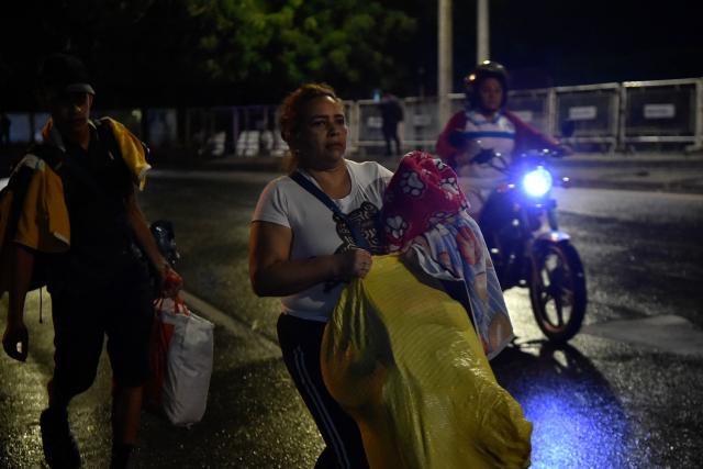 Venezuelans leaving their country arrive at the border crossing in Cucuta, Colombia, on January 3, 2026, after US forces had captured Venezuelan leader Nicolas Maduro after launching a "large scale strike" on the South American country.  (Photo by Schneyder Mendoza / AFP)