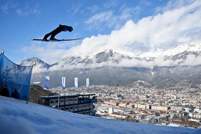 Germany's Andreas Wellinger soars through the air during the training round of the Men's Individual Large Hill HS128 event of the FIS Ski Jumping World Cup, the third leg of the Four Hills Tournament, in Innsbruck, Austria on January 3, 2026. (Photo by KERSTIN JOENSSON / AFP)