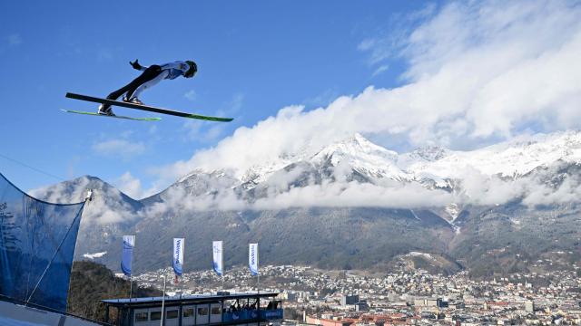 Austria's Jonas Schuster soars through the air during the training round of the Men's Individual Large Hill HS128 event of the FIS Ski Jumping World Cup, the third leg of the Four Hills Tournament, in Innsbruck, Austria on January 3, 2026. (Photo by KERSTIN JOENSSON / AFP)
