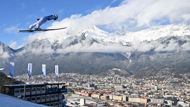 Japan's Naoki Nakamura soars through the air during the training round of the Men's Individual Large Hill HS128 event of the FIS Ski Jumping World Cup, the third leg of the Four Hills Tournament, in Innsbruck, Austria on January 3, 2026. (Photo by KERSTIN JOENSSON / AFP)