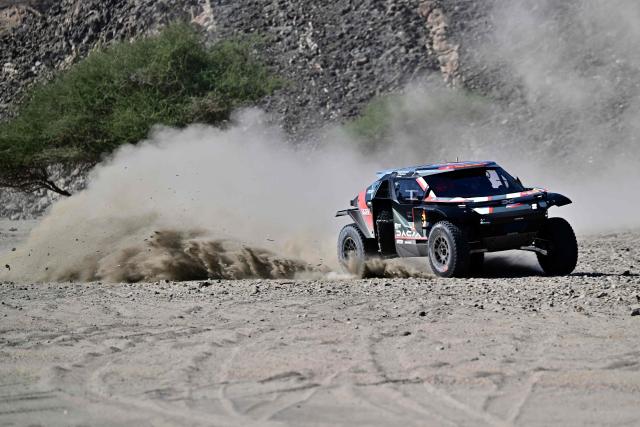 Dacia Sandriders French driver Sebastian Loeb and French co-driver Edouard Boulanger compete in the prologue, which determines the starting line-up for the first stage of the 48th edition of the Dakar Rally 2026, between Yanbu and Yanbu, Saudi Arabia, on January 3, 2026. (Photo by Giuseppe CACACE / AFP)