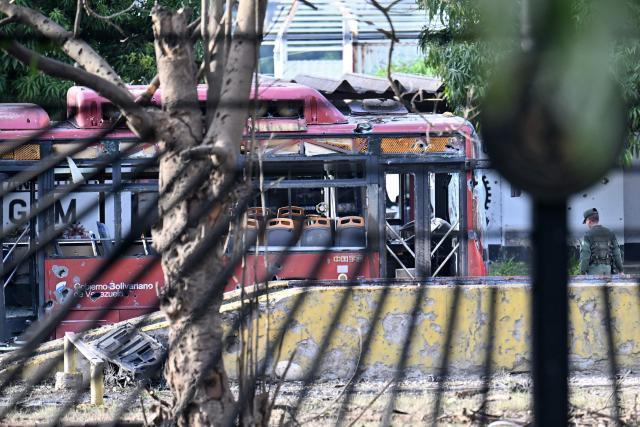 View of a destroyed bus at La Carlota air base in Caracas on December 3, 2026. President Donald Trump said Saturday that US forces had captured Venezuela's leader Nicolas Maduro after bombing the capital Caracas and other cities in a dramatic climax to a months-long standoff between Trump and his Venezuelan arch-foe. (Photo by Juan BARRETO / AFP)