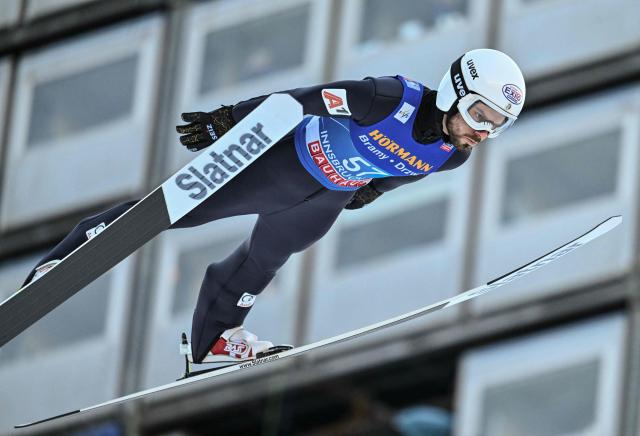 Bulgaria's Vladimir Zografski soars through the air during the qualification round of the Men's Individual Large Hill HS128 event of the FIS Ski Jumping World Cup, the third leg of the Four Hills Tournament, in Innsbruck, Austria on January 3, 2026. (Photo by KERSTIN JOENSSON / AFP)