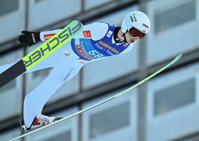Poland's Kacper Tomasiak soars through the air during the qualification round of the Men's Individual Large Hill HS128 event of the FIS Ski Jumping World Cup, the third leg of the Four Hills Tournament, in Innsbruck, Austria on January 3, 2026. (Photo by KERSTIN JOENSSON / AFP)