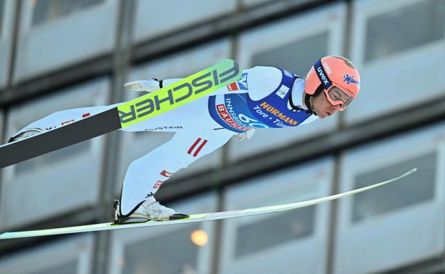 Austria's Stefan Kraft soars through the air during the qualification round of the Men's Individual Large Hill HS128 event of the FIS Ski Jumping World Cup, the third leg of the Four Hills Tournament, in Innsbruck, Austria on January 3, 2026. (Photo by KERSTIN JOENSSON / AFP)