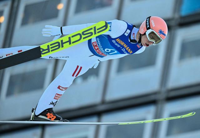 Austria's Jan Hoerl soars through the air during the qualification round of the Men's Individual Large Hill HS128 event of the FIS Ski Jumping World Cup, the third leg of the Four Hills Tournament, in Innsbruck, Austria on January 3, 2026. (Photo by KERSTIN JOENSSON / AFP)