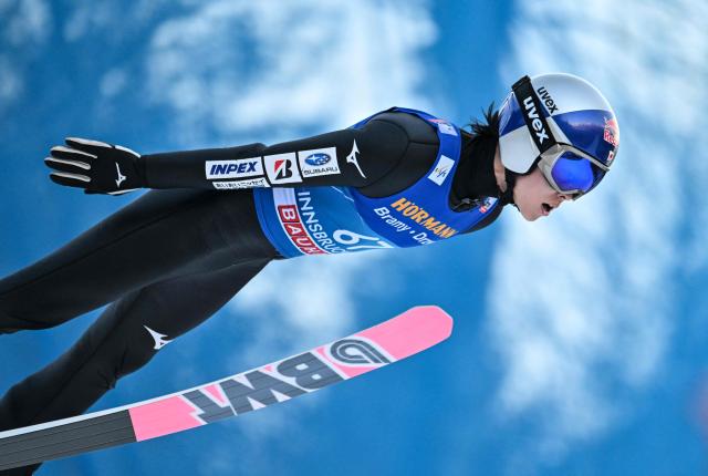 Japan's Ryoyu Kobayashi soars through the air during the qualification round of the Men's Individual Large Hill HS128 event of the FIS Ski Jumping World Cup, the third leg of the Four Hills Tournament, in Innsbruck, Austria on January 3, 2026. (Photo by KERSTIN JOENSSON / AFP)