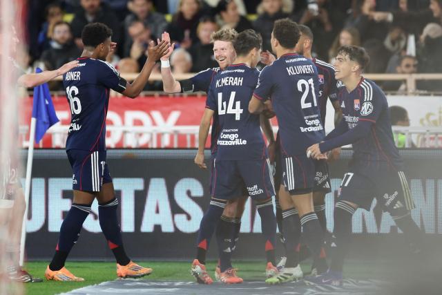 Lyon's Czech midfielder #10 Pavel Sulc (C-L) celebrates scoring his team's first goal during the French L1 football match between AS Monaco and Olympique Lyonnais (OL) at the Stade Louis II in the Principality of Monaco on January 3, 2026. (Photo by Valery HACHE / AFP)