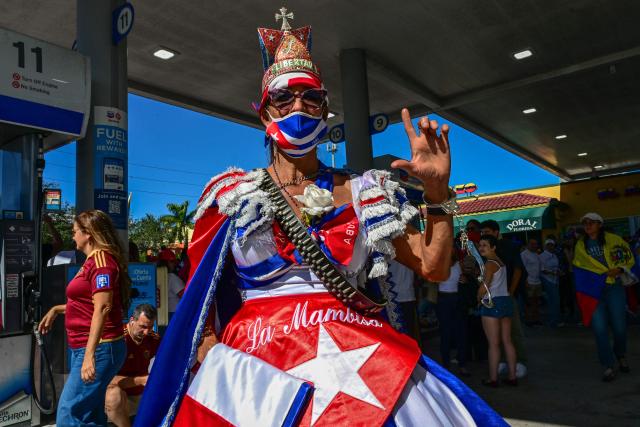 People react to the news of the capture of Venezuelan President Nicolas Maduro, after US military actions in Venezuela this morning, in Doral, Florida, near Miami on January 3, 2026. President Trump said Saturday that US forces had captured Venezuelan leader Nicolas Maduro after launching a "large scale strike" on the South American country. (Photo by GIORGIO VIERA / AFP)